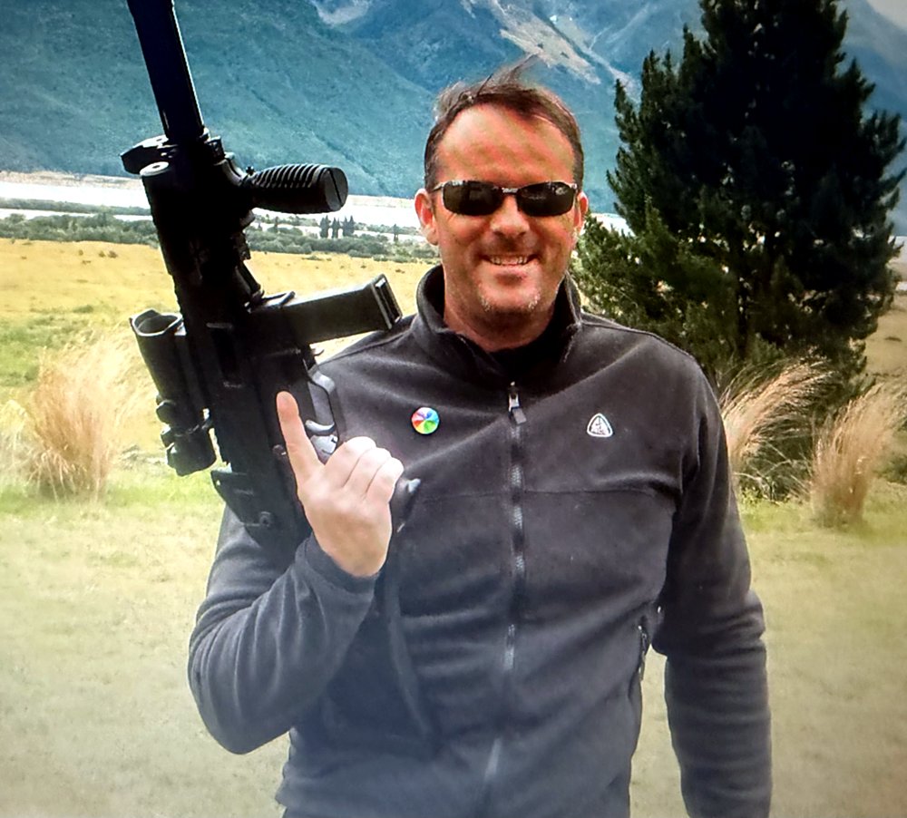 Ken King on location in the high country, holding a rifle